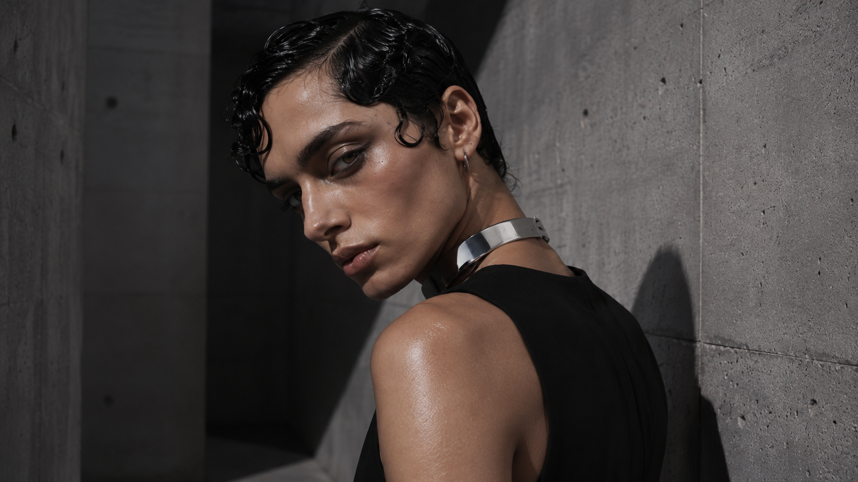 Turned-shoulder portrait, chrome collar against concrete
