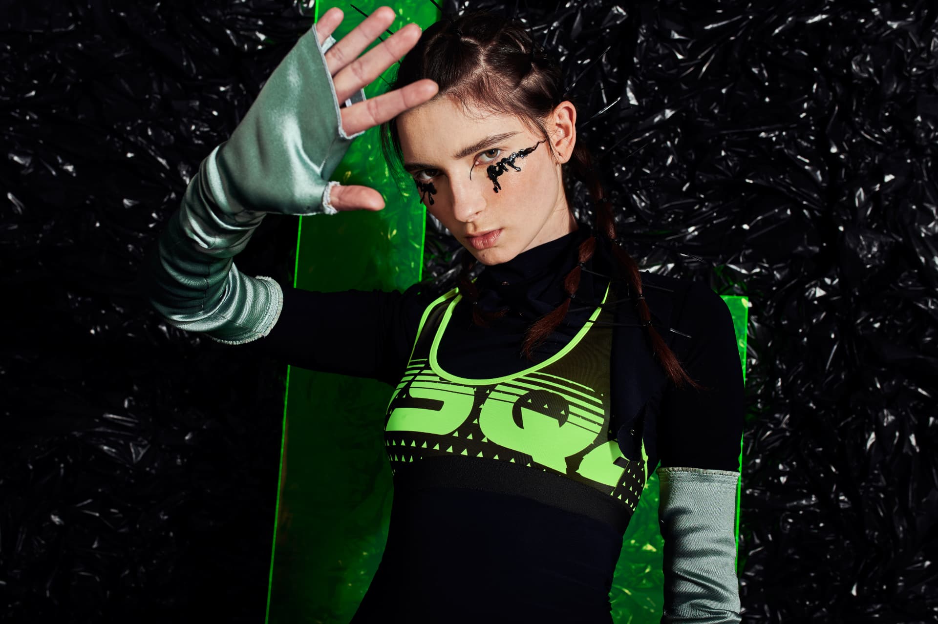 Raised hand, acid green panel and metallic satin sleeves